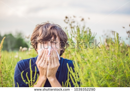 stock-photo-young-man-sneezes-because-of-an-allergy-to-ragweed-1039352290